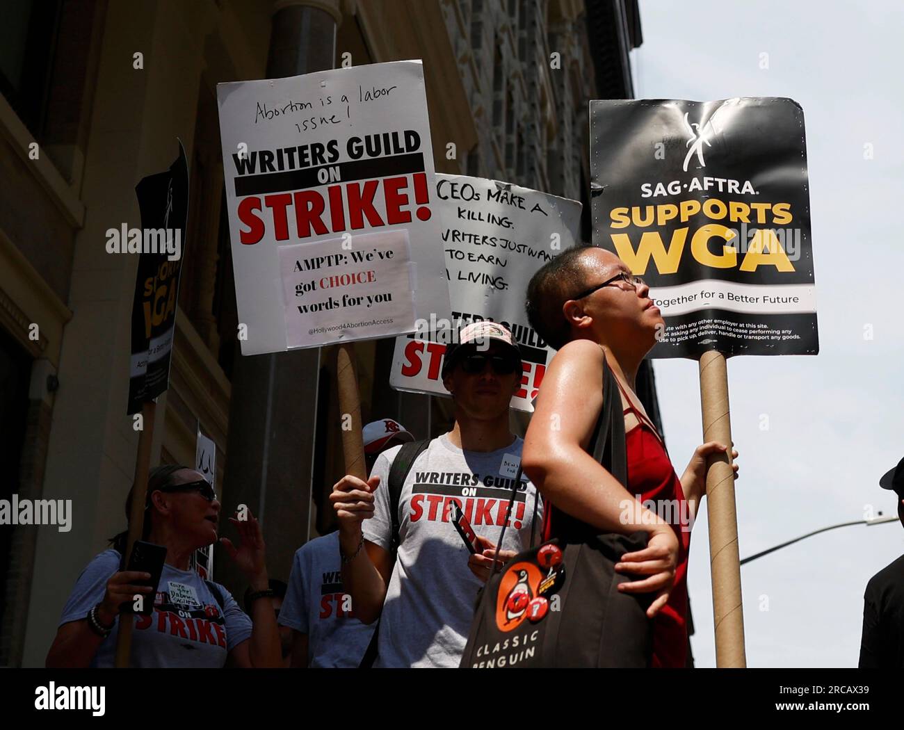 New York, United States. 13th July, 2023. Members of the Writers Guild of America East are joined by SAG-AFTRA members as they both hold up signs picketing outside of the Warner Bros. Discovery office on Thursday July 13, 2023 in New York City. SAG-AFTRA representing 160,000 television and movie actors are set to strike joining screenwriters who have been picketing since May due to a range of issues including pay and the use of artificial intelligence. Photo by John Angelillo/UPI Credit: UPI/Alamy Live News Stock Photo