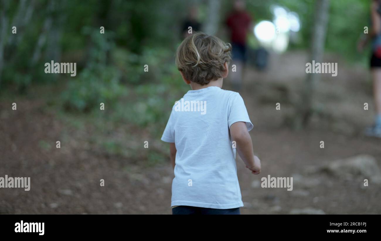 Tired little boy climbing mountain wanting rest child complaining Stock