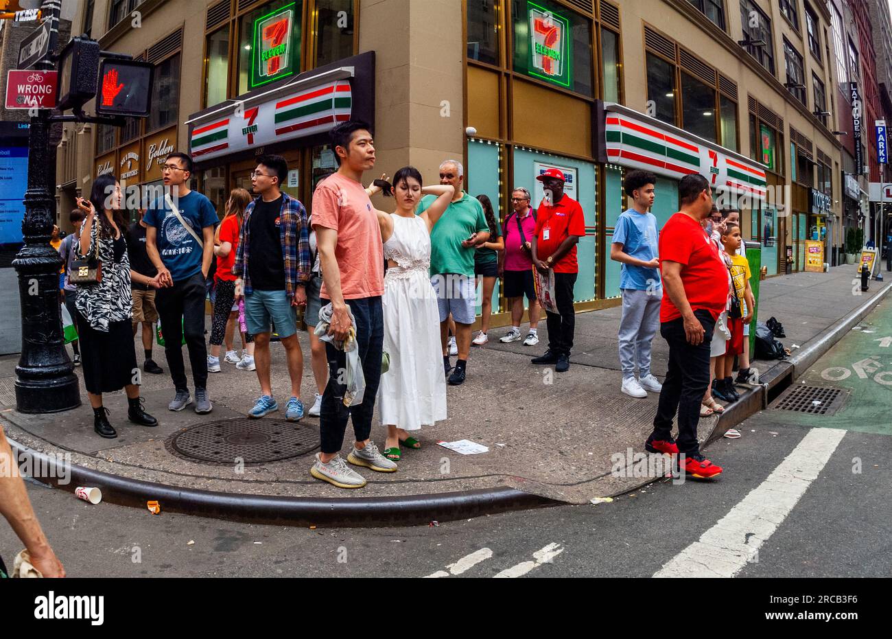 Busy corner in front of a 7Eleven convenience store in Midtown