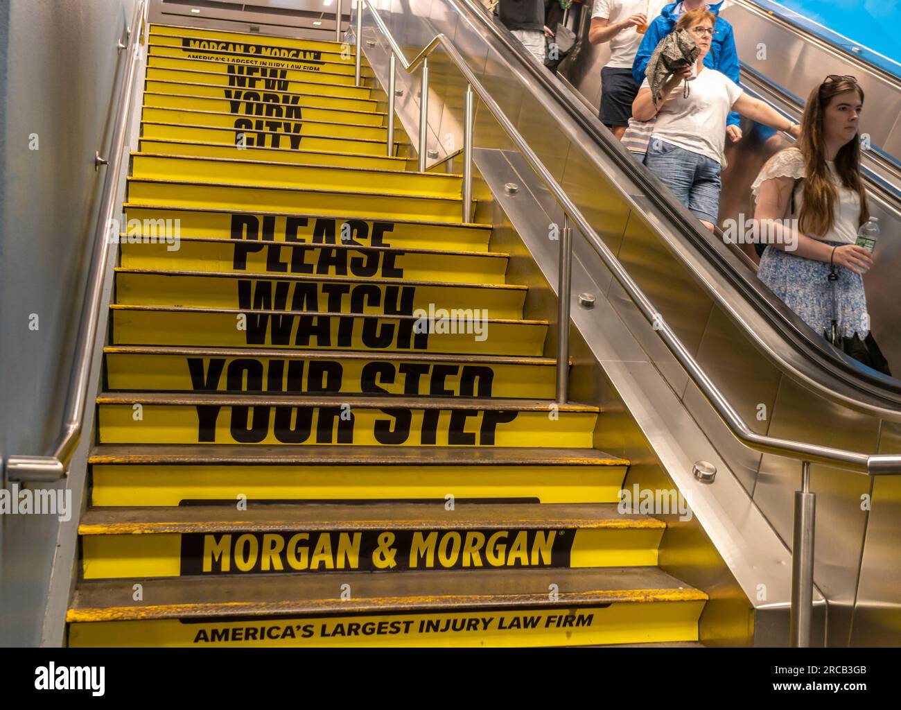Stairs in Penn Station in New York carry advertising warning people to watch their step, from the Morgan & Morgan personal injury law firm, seen on Tuesday, July 4, 2023. (© Richard B. Levine) Stock Photo