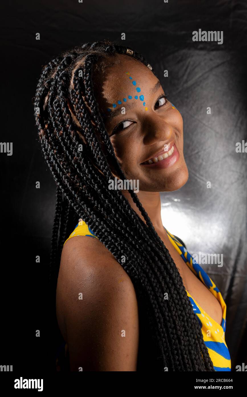 Portrait of a beautiful black woman with long braids in her hair and ...
