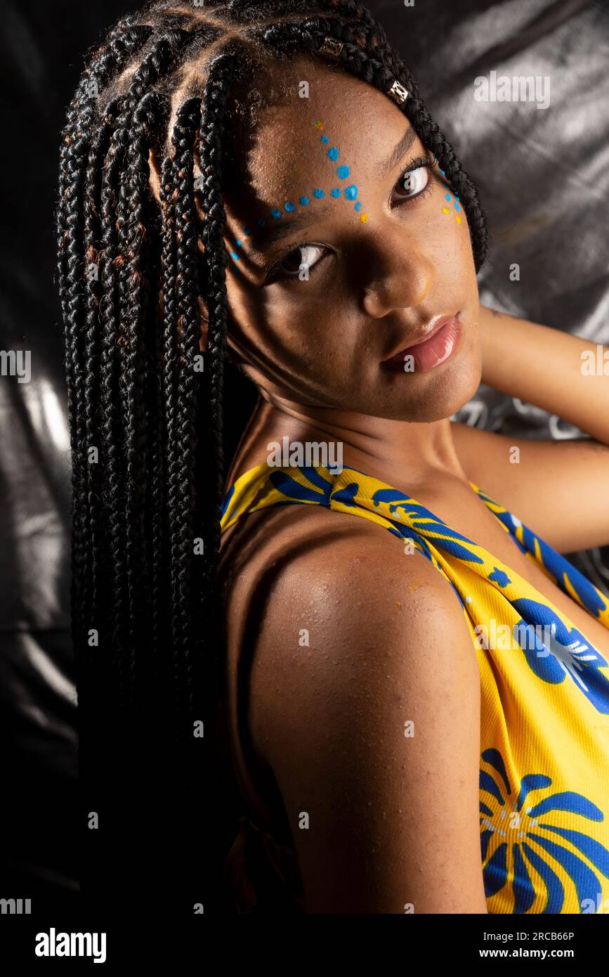 Portrait of a beautiful black woman with long braids in her hair and ...