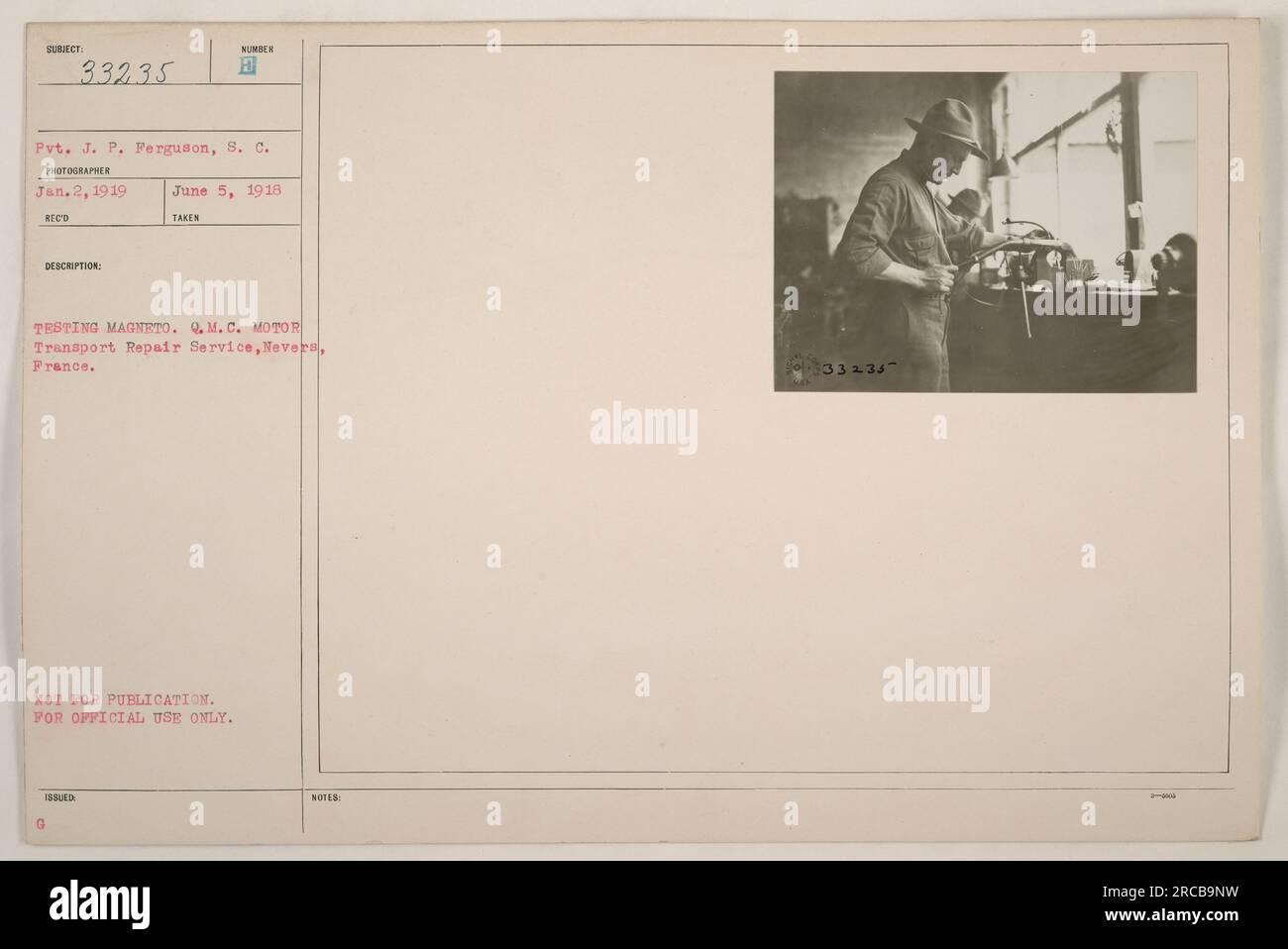 A soldier, identified as Pvt. J. P. Ferguson, is testing a magneto at the Motor Transport Repair Service in Nevers, France. The photograph was taken on January 2, 1919, by photographer S. C. NOT FOR PUBLICATION or OFFICIAL USE. Stock Photo