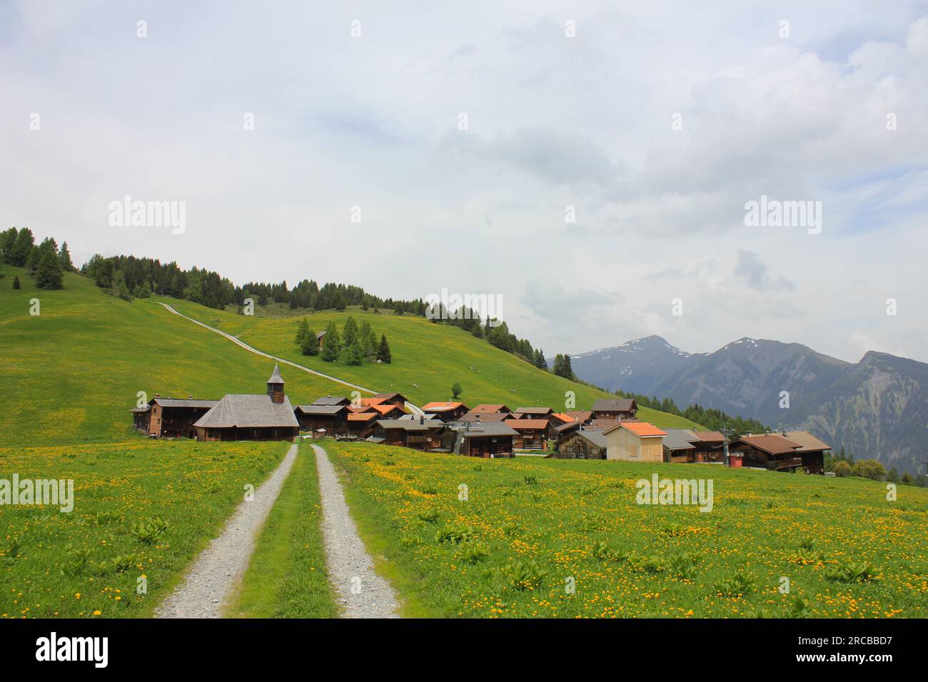 Swiss village situated high up on a hill top. Early summer Stock Photo