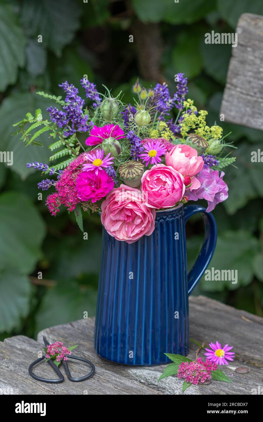 romantic bouquet of pink roses and summer flowers in garden Stock Photo