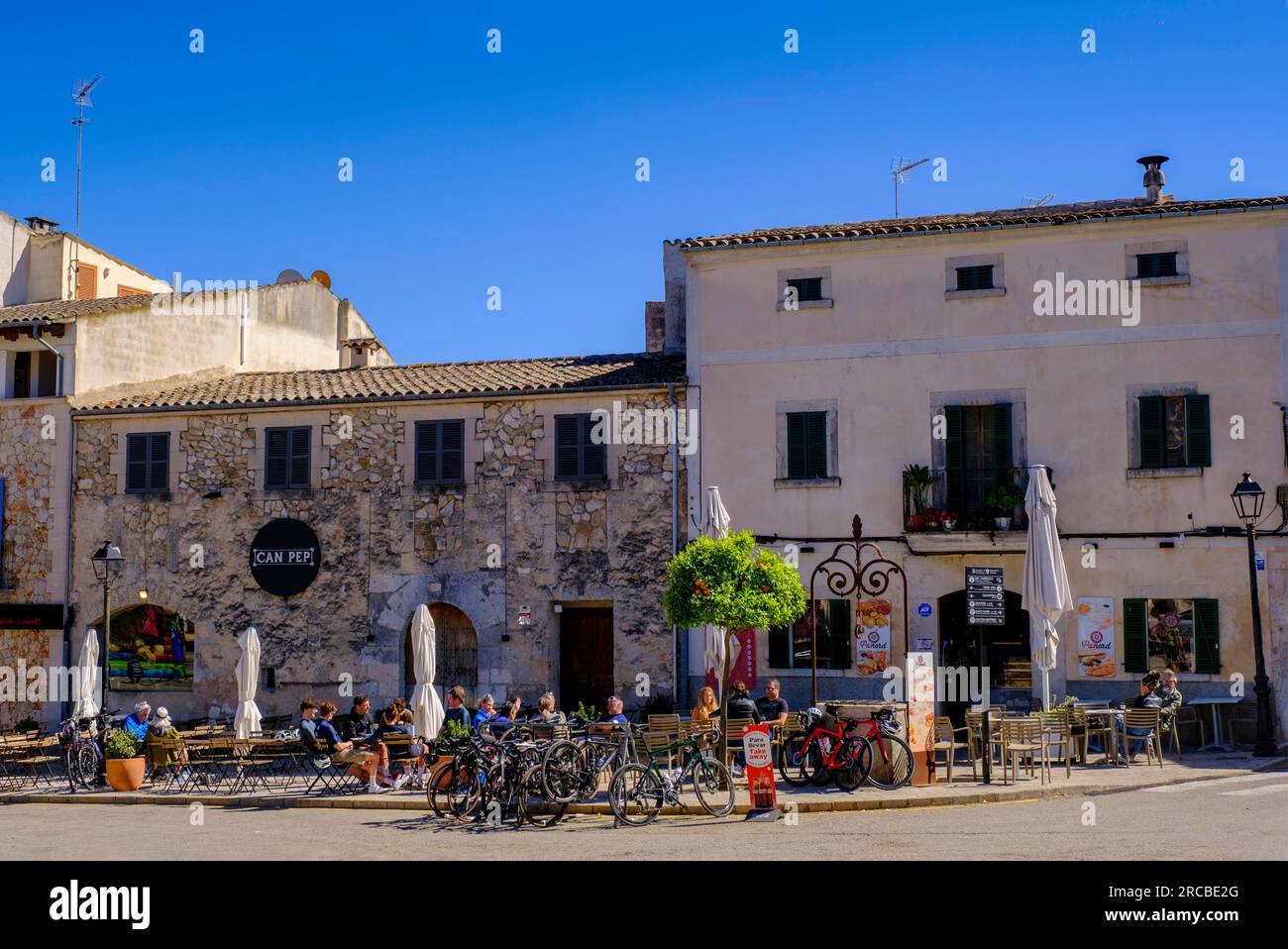 Sidewalk cafes in front of the church, Santa Maria de Sineu, Sa Placa, Sineu, Majorca, Balearic Islands, Spain Stock Photo