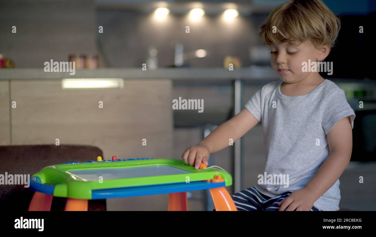 Child plays with drawing board becoming agitated and frustrated ADHD ...