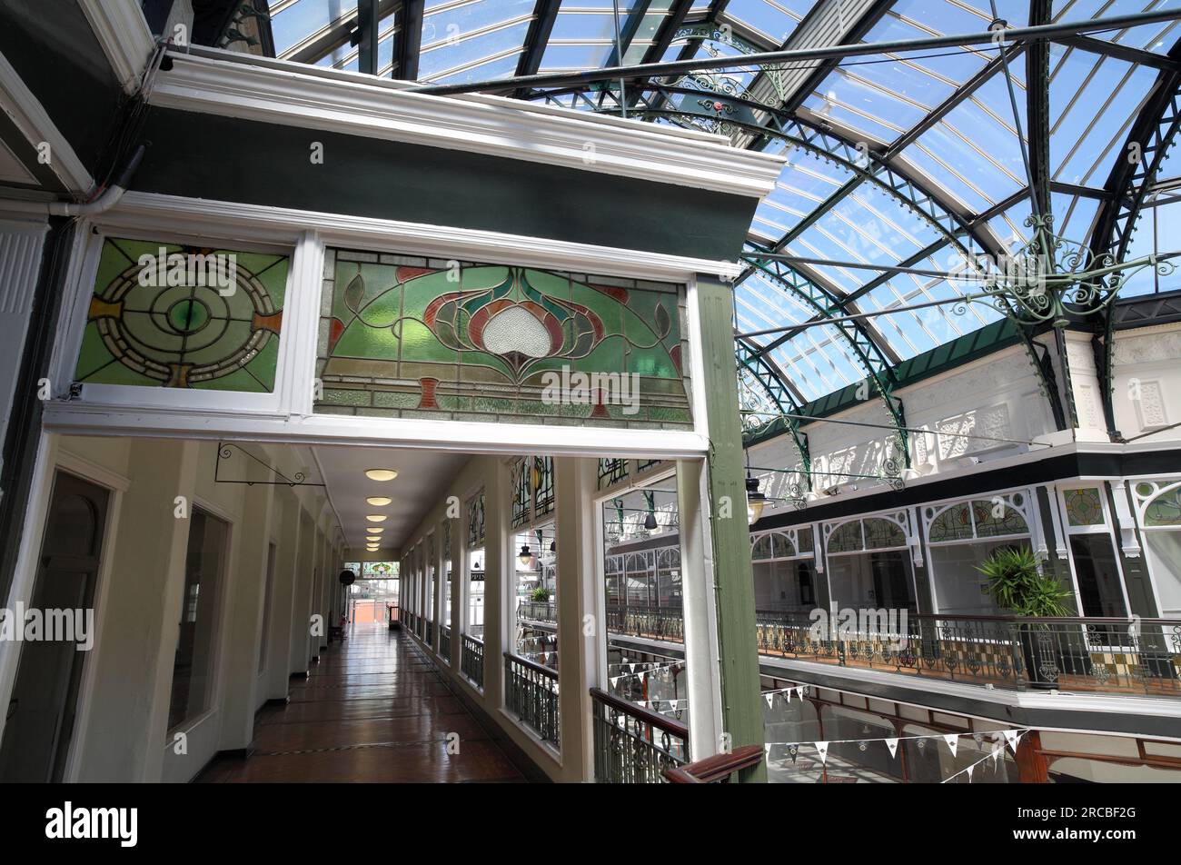 Art Nouveau coloured glass adorns an upper level gallery inside the Wayfarer's Arcade, off Lord Street, Southport. Stock Photo