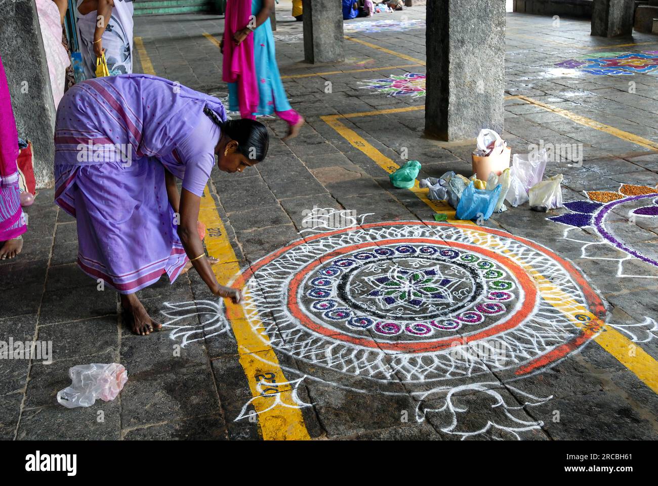 Drawing kolam, rangoli inside the temple floor, Sri Neelayadhakshi