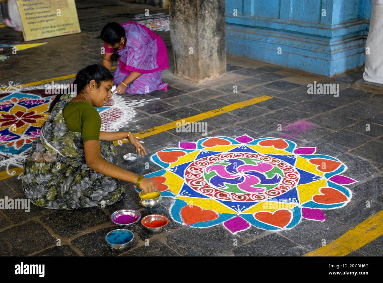 Drawing kolam, rangoli inside the temple floor, Sri Neelayadhakshi