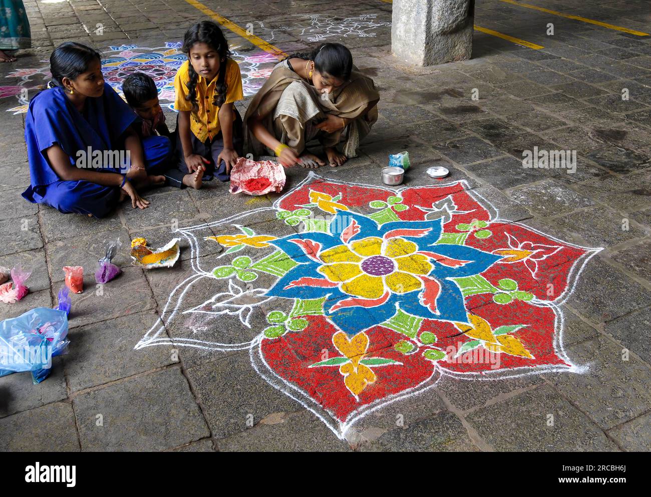 Drawing kolam, rangoli inside the temple floor, Sri Neelayadhakshi