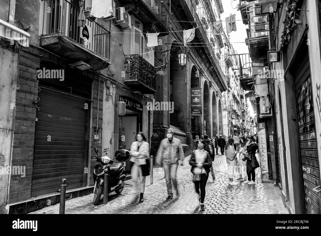 Naples, Italy - April 9, 2022: Spaccanapoli is the straight and narrow main street that traverses the old, historic center of the city of Naples, Ital Stock Photo