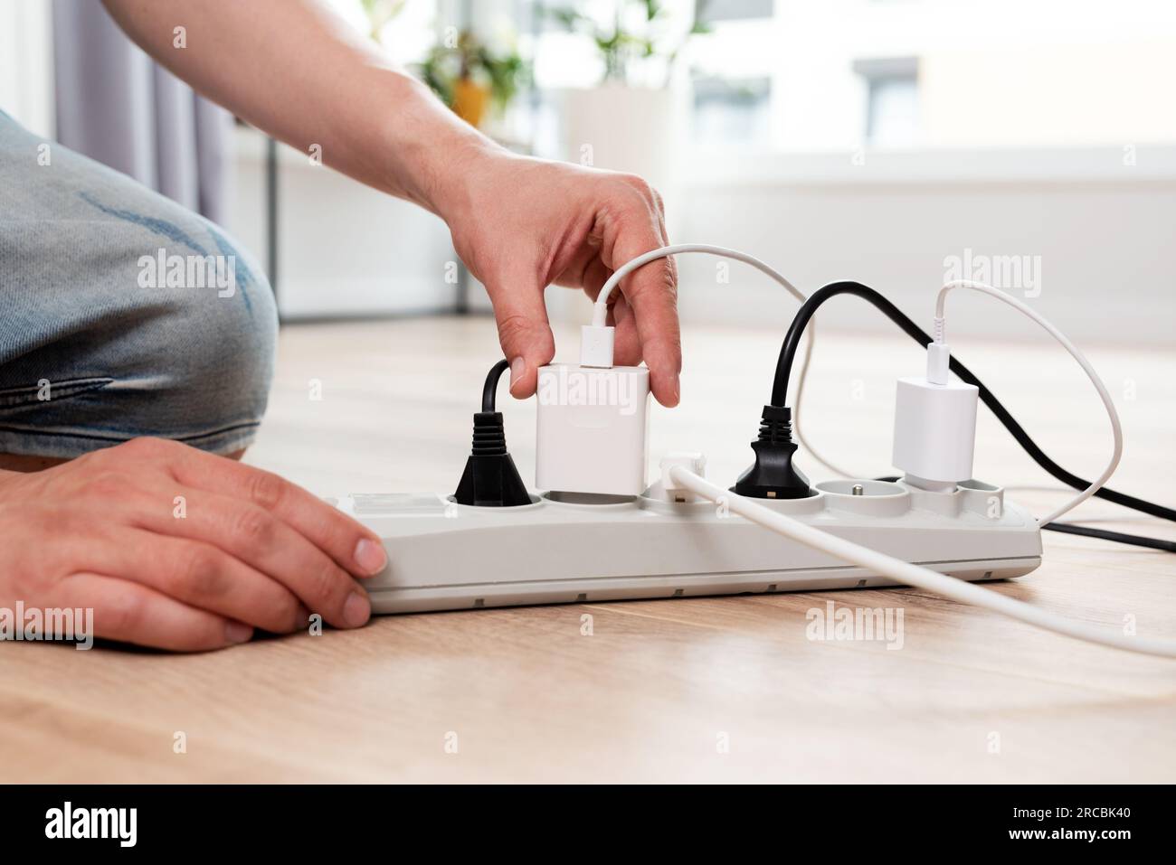 Electrical plug in outlet socket at home. Energy efficiency concept Stock Photo
