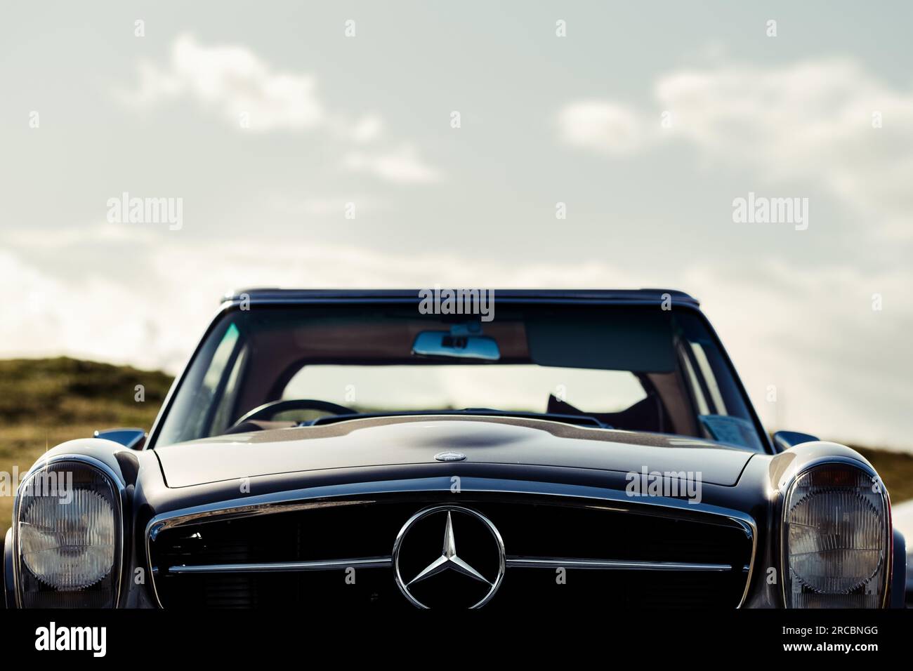 Oldtimer mercedes benz car, low angle, front view with copyspace sky Stock Photo