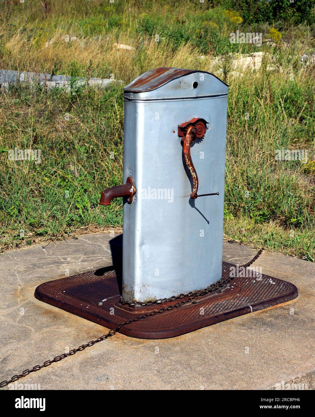 Old crank water pump and tank sits besides the Lower Fox Creek