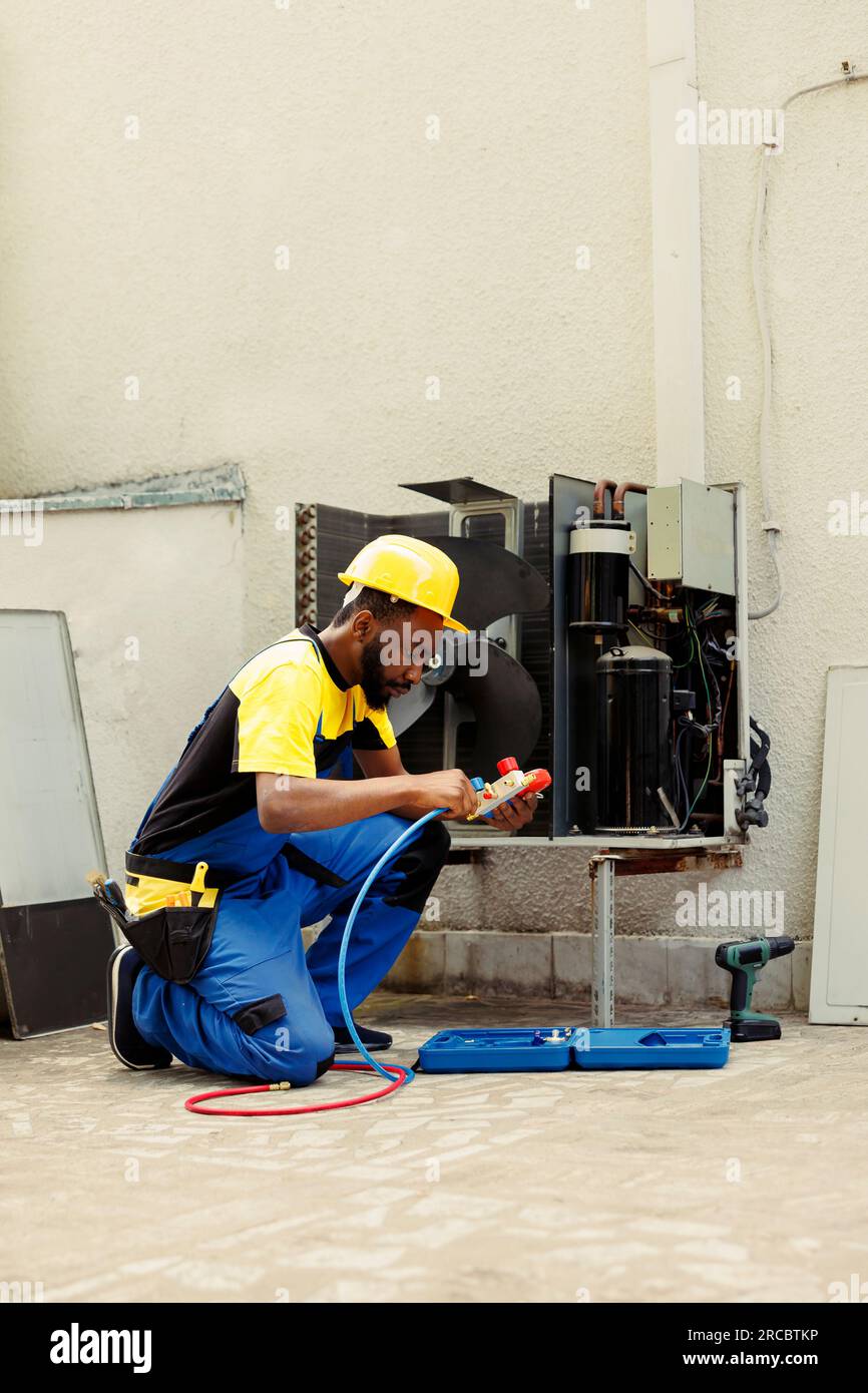 Seasoned mechanic doing yearly hvac system maintenance, assembling