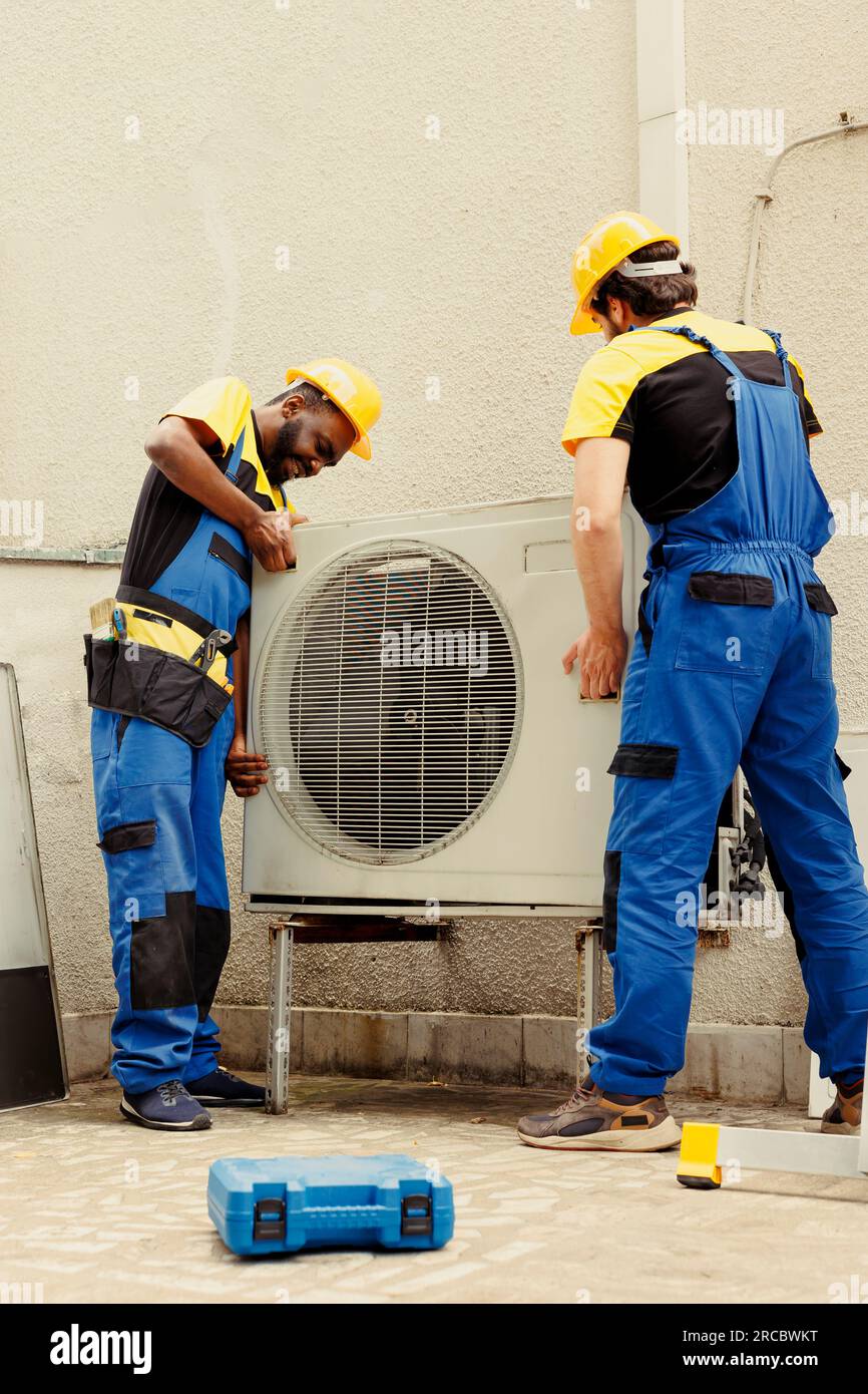 Professional worker and licensed serviceman taking apart old