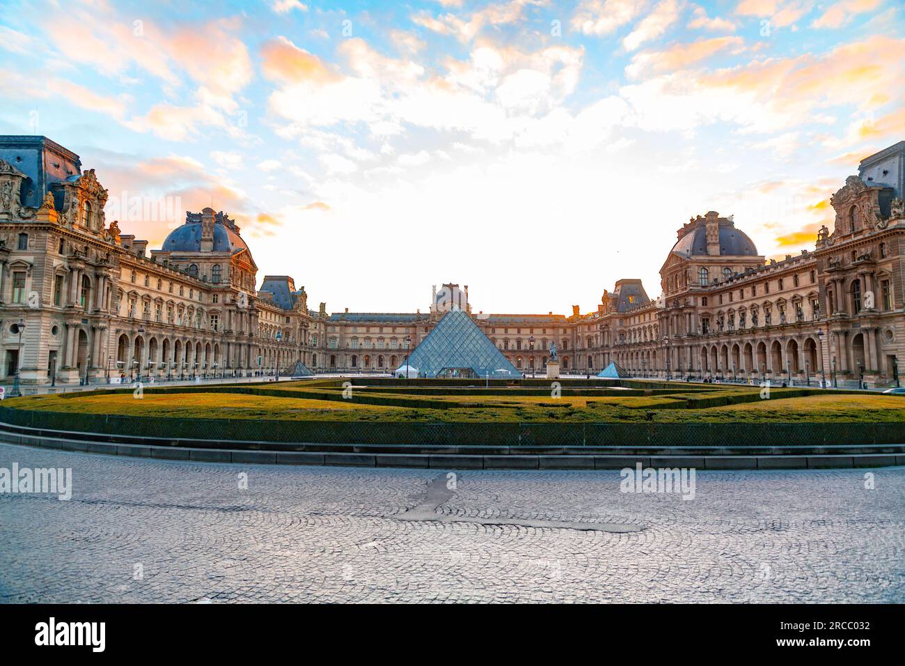 Paris, France - JAN 20, 2022: The glass pyramid of Louvre Museum, the main entrance to famous museum and gallery, completed in 1989. A beautiful winte Stock Photo