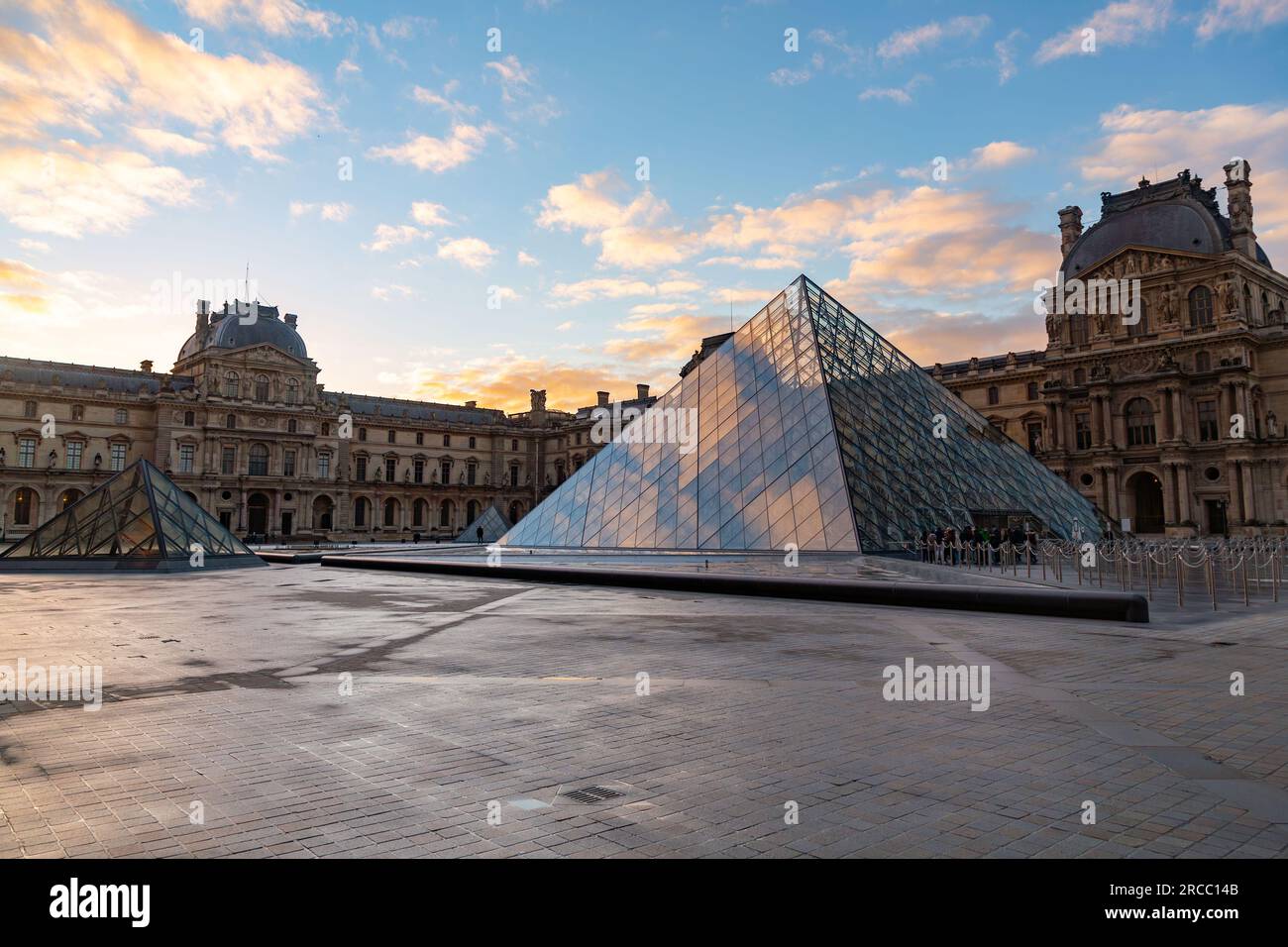 Paris, France - JAN 20, 2022: The glass pyramid of Louvre Museum, the main entrance to famous museum and gallery, completed in 1989. Stock Photo