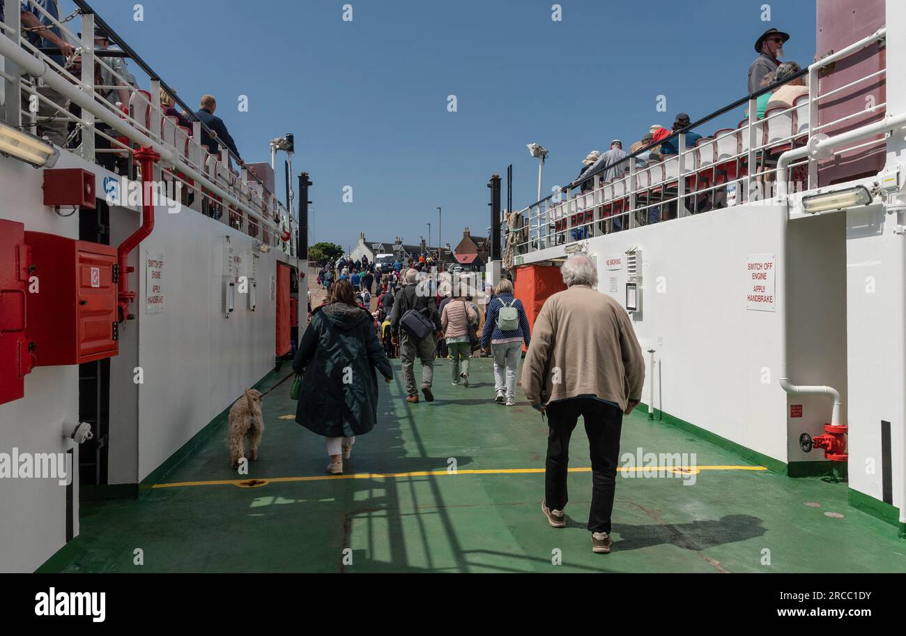 Isle of Iona, Scotland, UK, 6 June 2023. The CalMac ferry  Loch Buie in  Iona with foot passengers disembarking from lower deck to the village. Stock Photo