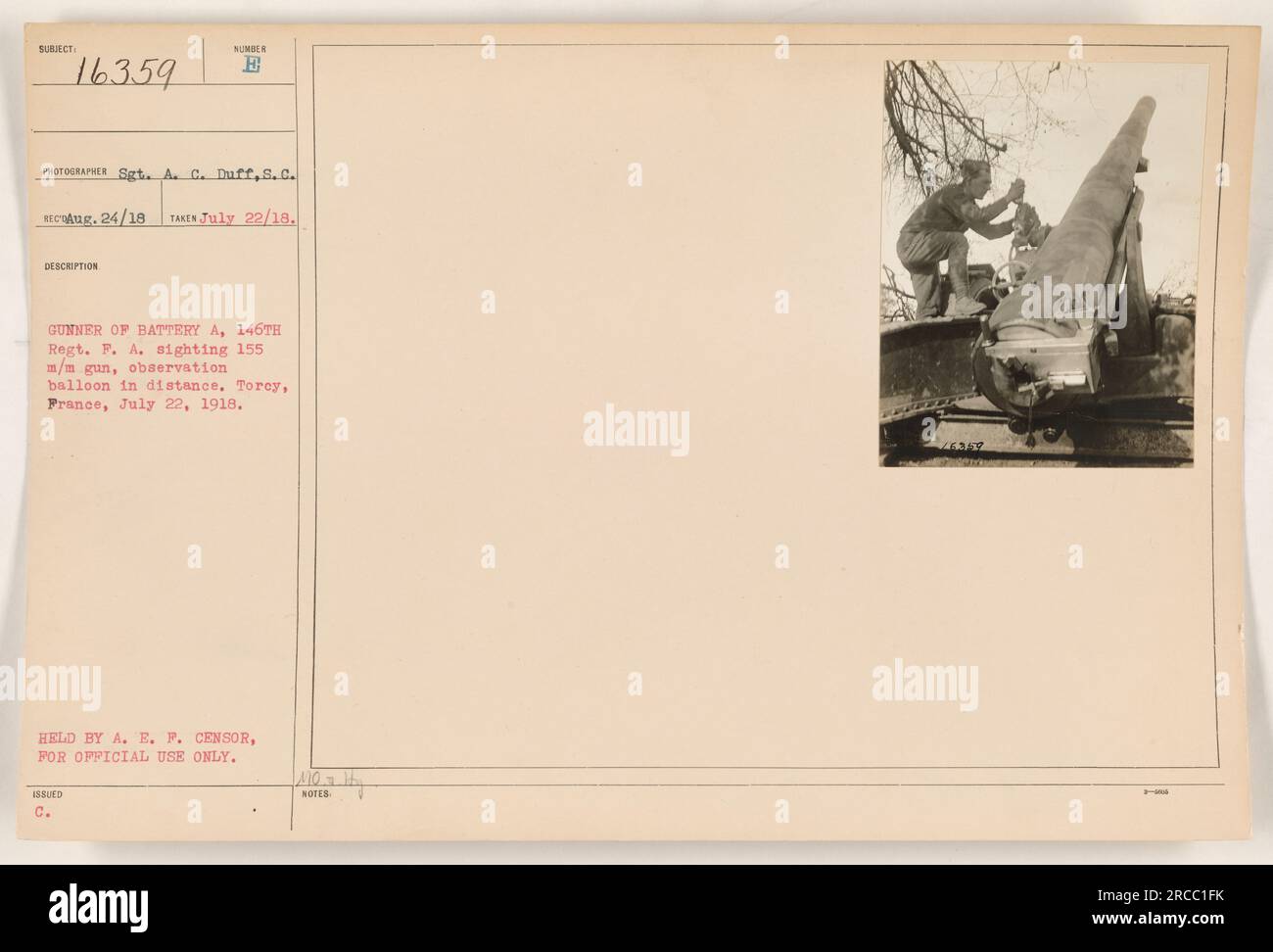 'Soldier from Battery A, 146th Regiment of Field Artillery, sighting a 155 mm gun with an observation balloon in the distance. This photo was taken on July 22, 1918 in Torcy, France. It was issued by the American Expeditionary Forces censor for official use only.' Stock Photo