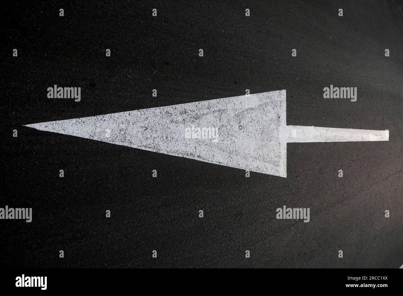 Long white arrow pointing left on black background, angled perspective ...