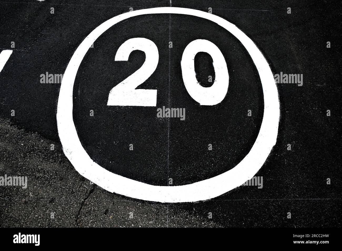 Number 20, speed limit twenty, white reflective paint road signage on ...