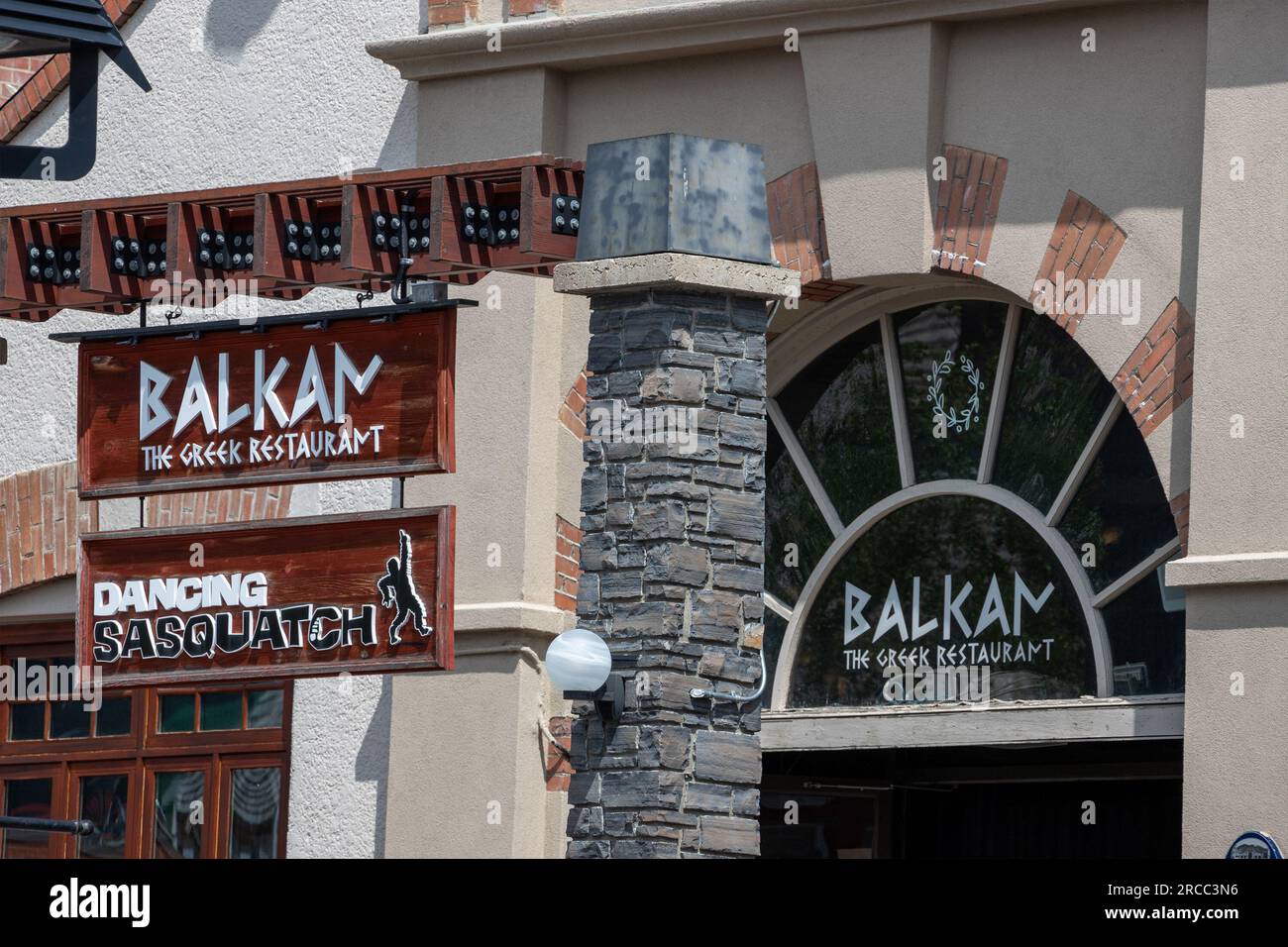 BANFF, CANADA - JULY 5, 2023 : Balkan the Greek Restaurant business sign on busy Banff Avenue in Alberta, Canada. It is a famous and popular Greek res Stock Photo