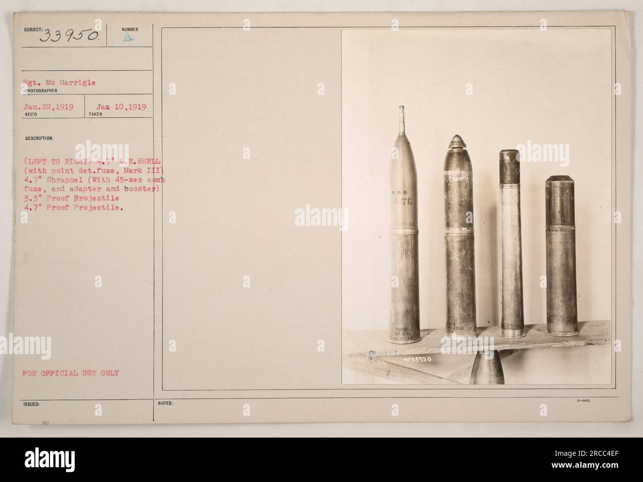 This image shows four types of artillery projectiles used during World War One. From left to right, they are a 4.7' high-explosive shell with point detonating fuze, a 4.7' shrapnel shell with a 45-second combination fuse and adapter, a 3.3' proof projectile, and another 4.7' proof projectile. The photograph was taken on January 22, 1919, by Sgt. Me Garrigle. Stock Photo