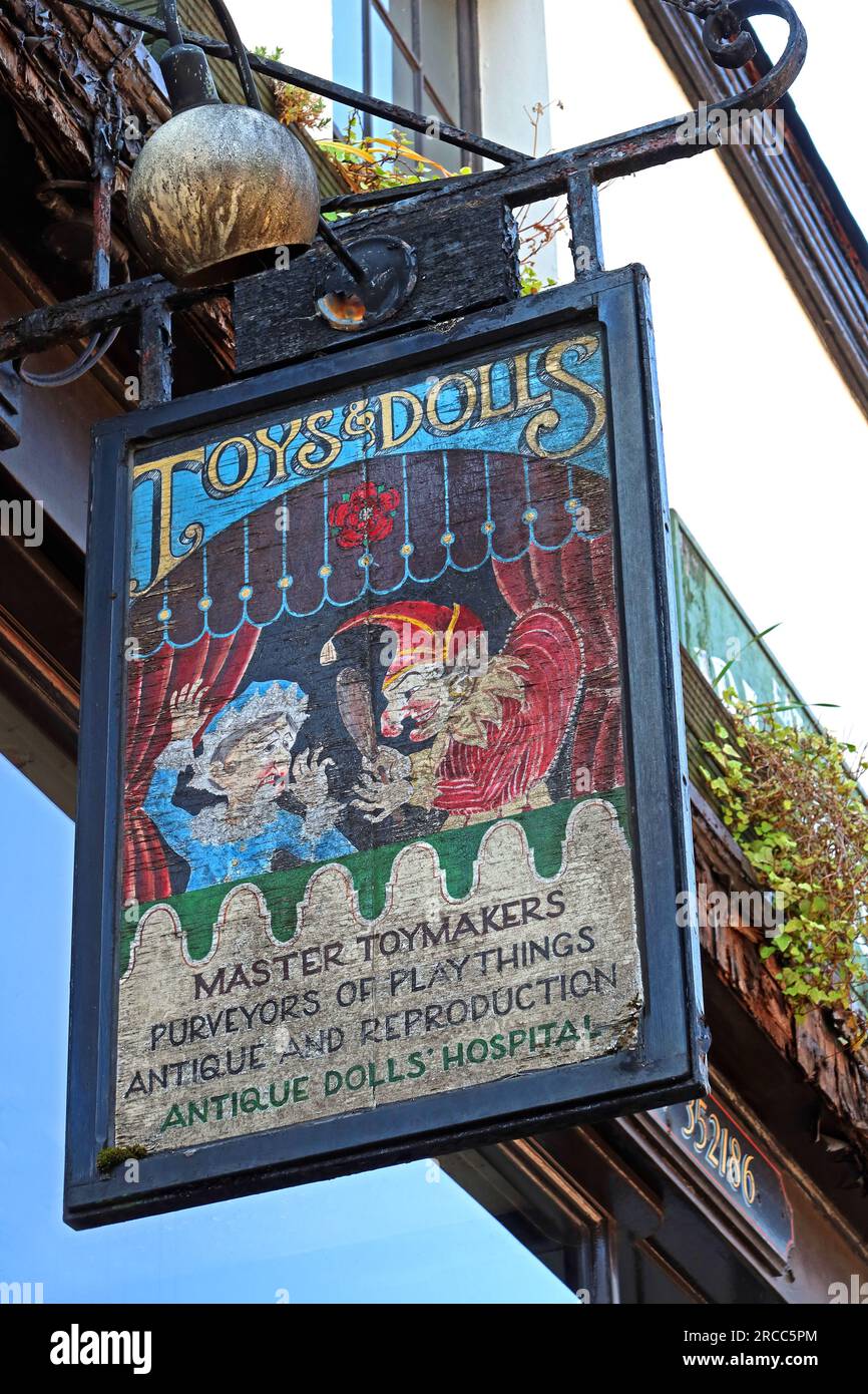 Hanging shop sign for The Dolls Hospital on Toad Lane in Rochdale, advertising toys, dolls, and antique doll restoration, Greater Manchester, England Stock Photo