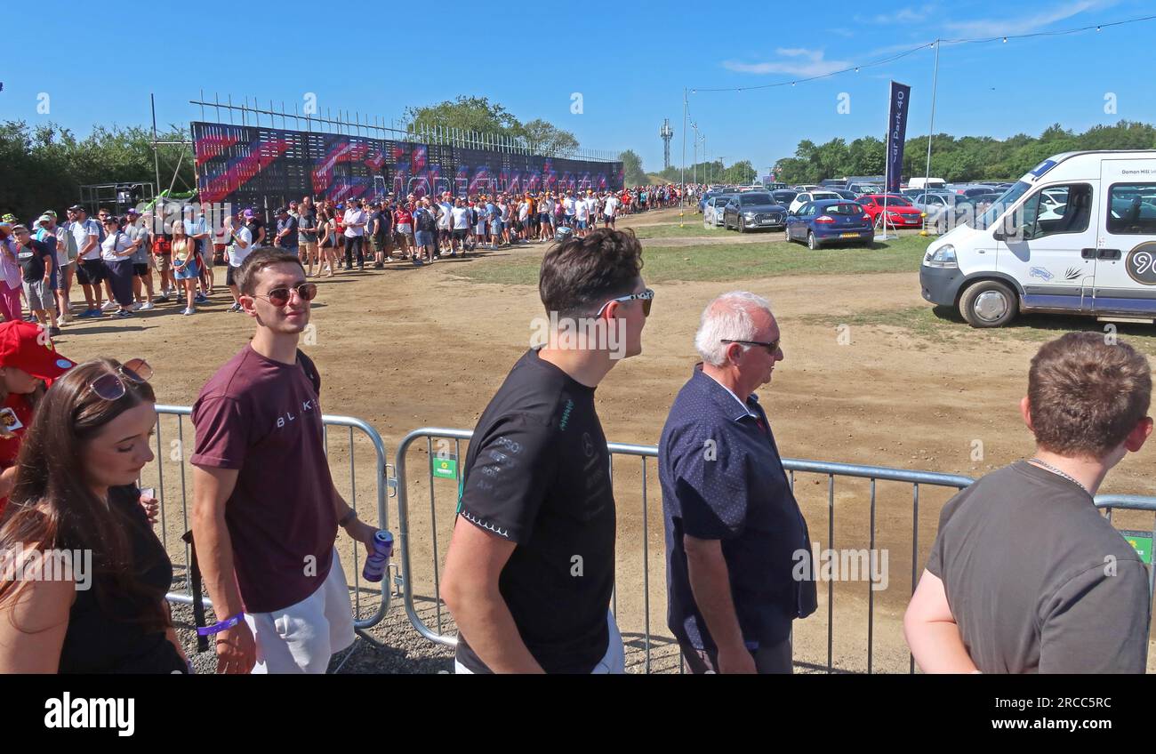 Fans queue to enter Silverstone Circuit during the Formula One British Grand Prix, passing through security checks and controlled access points/gates Stock Photo