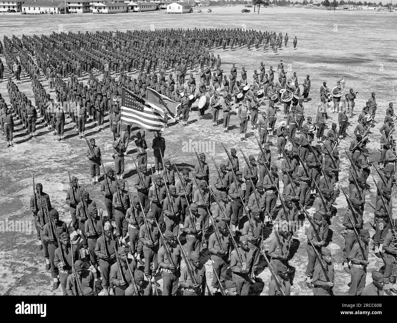 Soldiers of 41st Engineers in formation on Parade Ground with Sergeant Franklin Williams in color guard, Fort Bragg, North Carolina, USA, Arthur Rothstein, U.S. Office of War Information, March 1942 Stock Photo