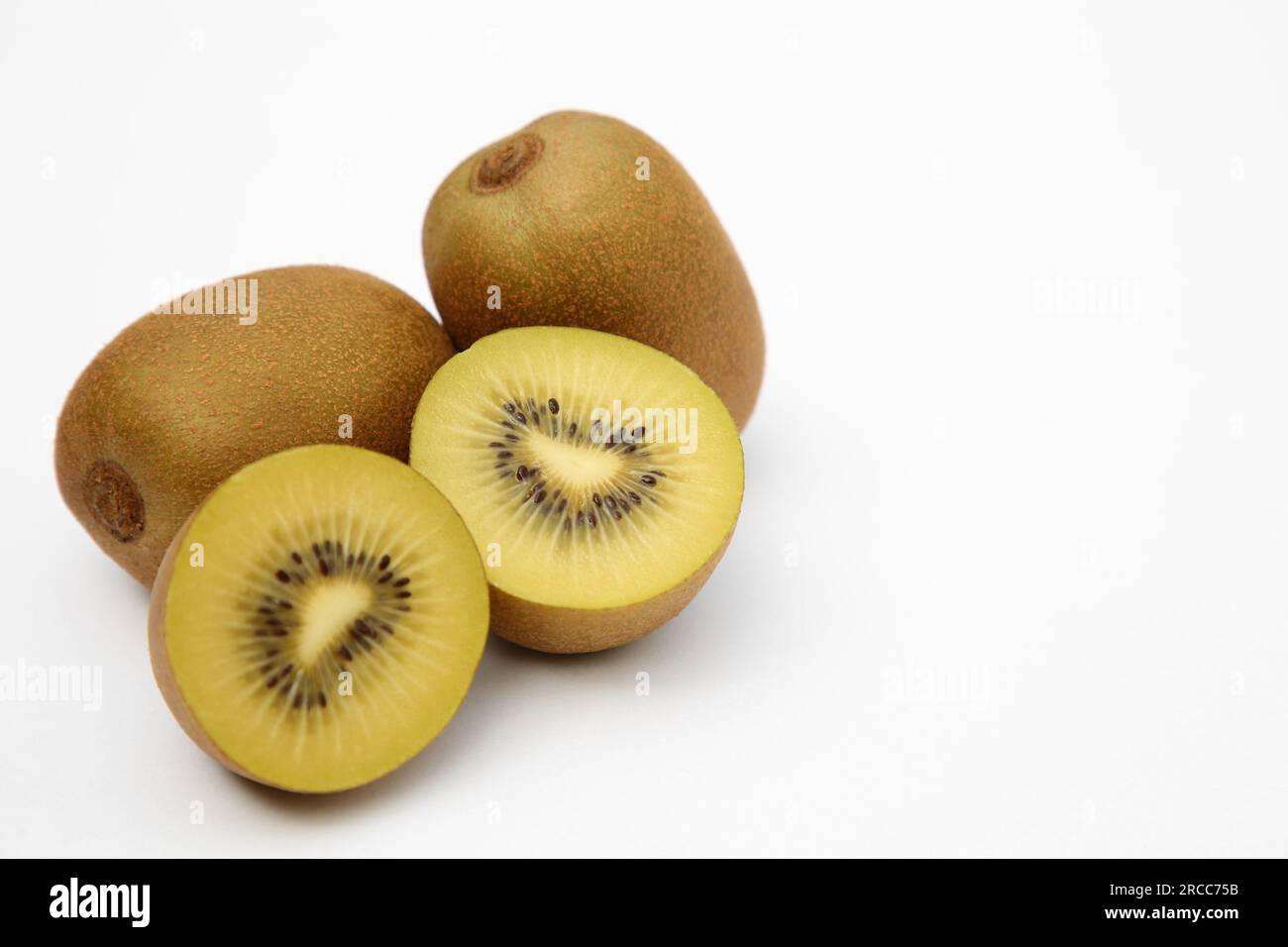 Whole and cut ripe yellow kiwis on white background Stock Photo - Alamy