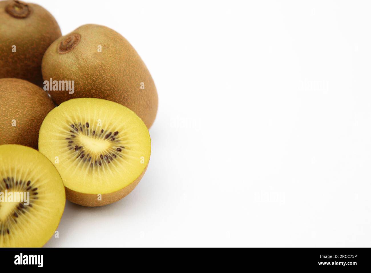 Whole and cut ripe yellow kiwis on white background Stock Photo - Alamy