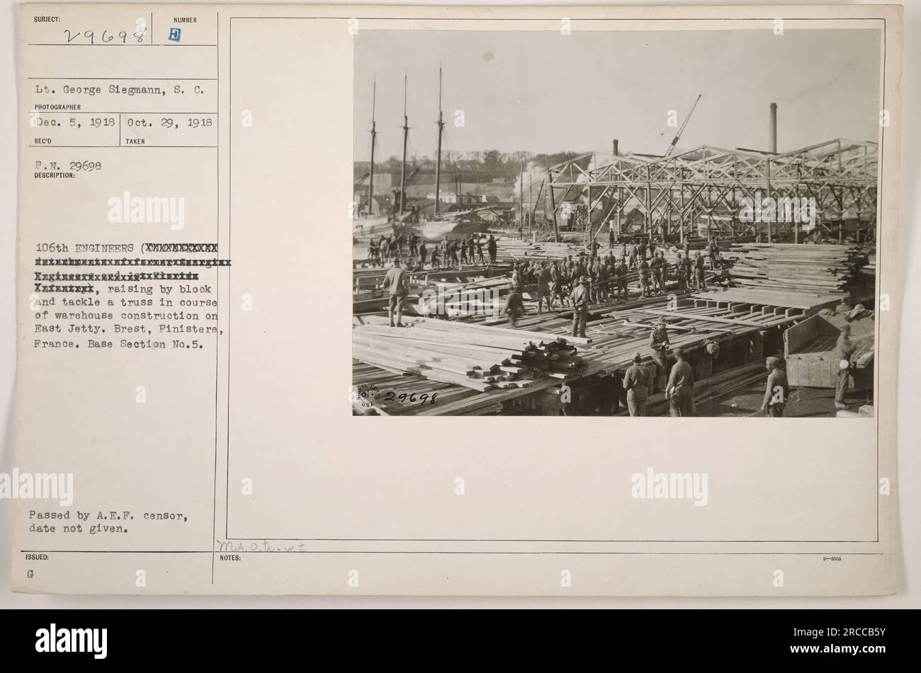 Lt. George Siegmann, of the 106th Engineers, is seen raising a block and tackle & truss during the construction of a warehouse on East Jetty in Brest, France. This photograph was taken on October 29, 1918, but the issue date is unknown. It passed censorship by the A.E.F. censor. Stock Photo