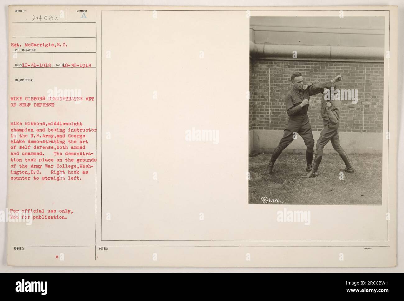 Sgt. MeGarrigle captures a photo of Mike Gibbons, U.S. Army's middleweight champion and boxing instructor, demonstrating the art of self-defense alongside George Blake at the Army War College in Washington D.C. The photo, taken on October 31, 1918, shows Gibbons employing a right hook as a counter to a straight left. This image is for official use only and should not be published. Stock Photo