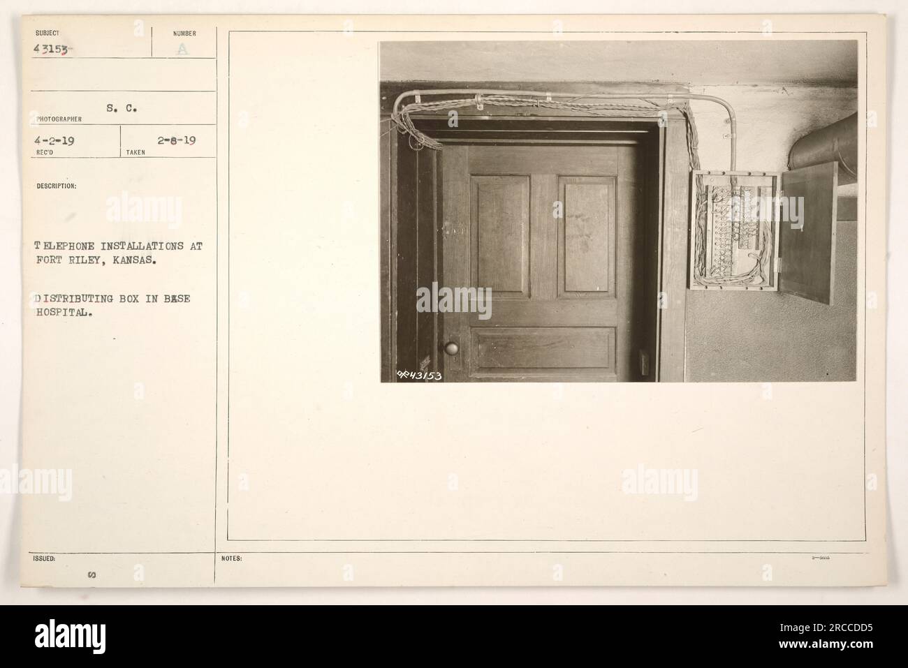 A photograph captured by S. C. Issled on February 8, 1919, at Fort Riley, Kansas. The image depicts the distribution box in the base hospital, showcasing one of the numerous telephone installations present at Fort Riley during World War One. (Image reference: 111-SC-43153) Stock Photo