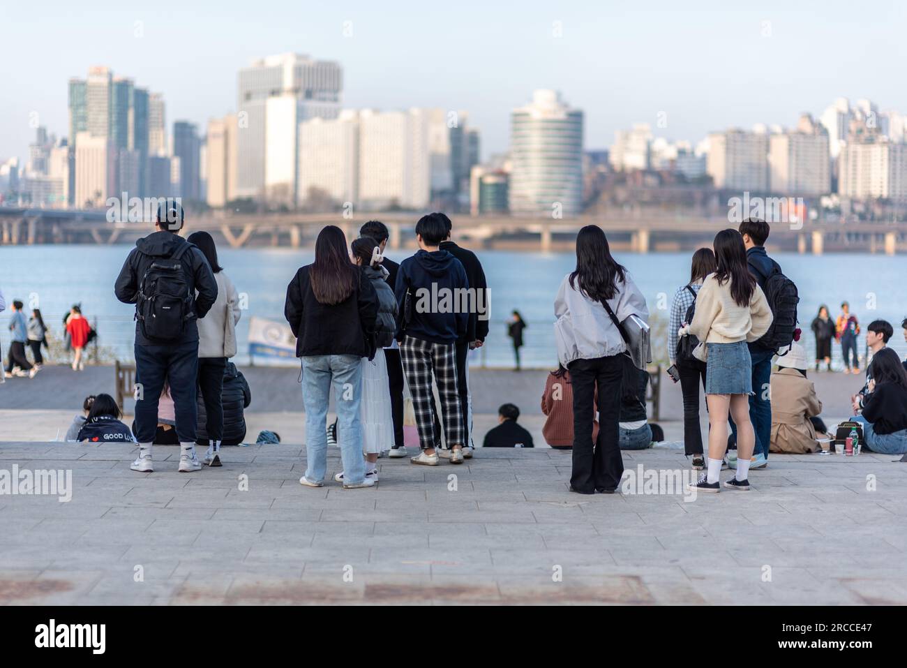 People picnicing in Yeouido park on Han river in Seoul, South Korea on 30 March 2023 Stock Photo