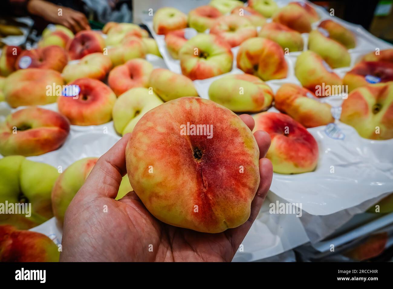 The donut peach, also known as the Saturn peach, is a delightful and