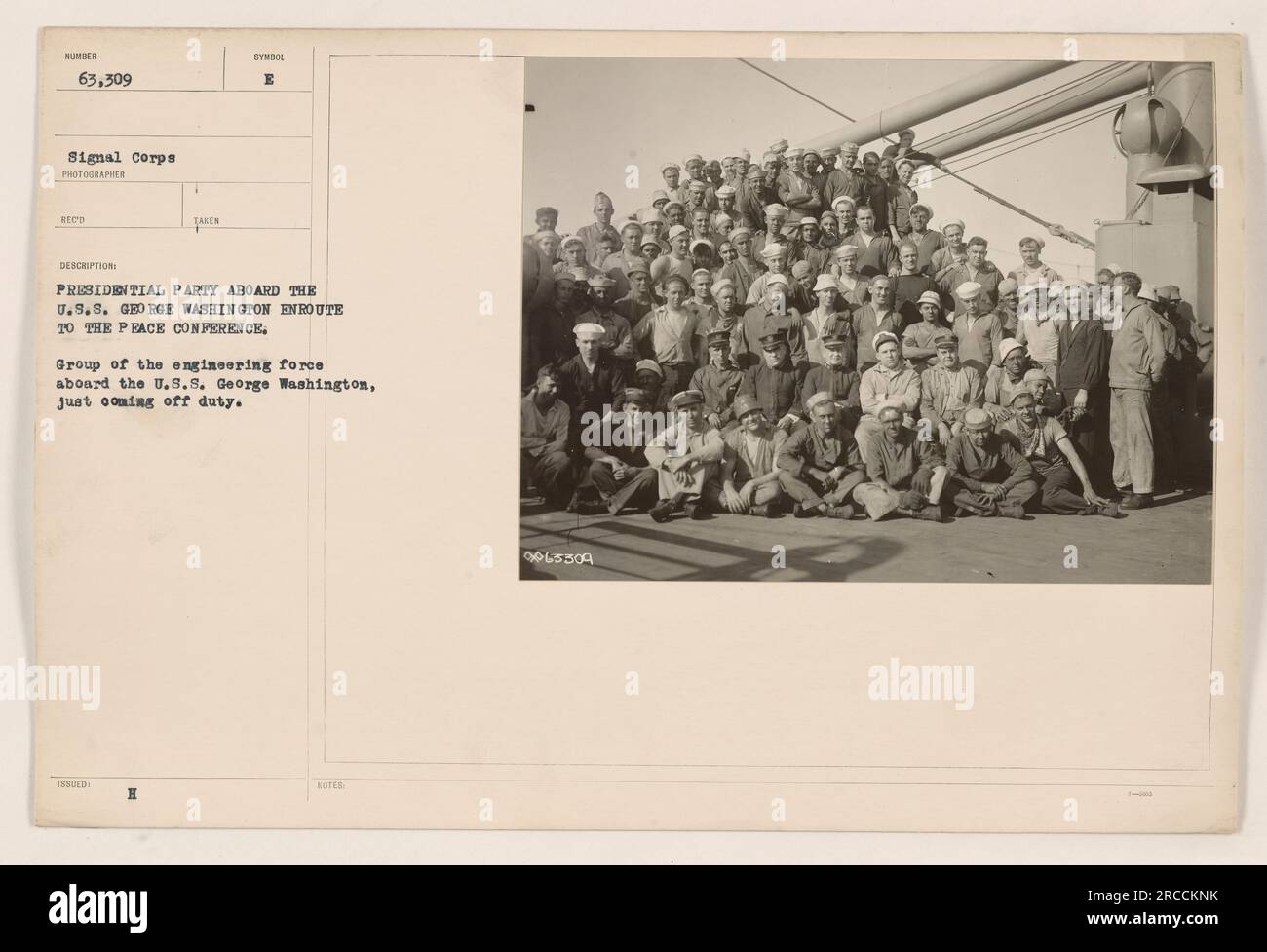 Group of engineers on the USS George Washington coming off duty during their journey to the Peace Conference as part of the Presidential party. Photograph taken by the Signal Corps, with the image description stating the photo was issued with symbol E. Caption includes the reference number 0065509. Stock Photo