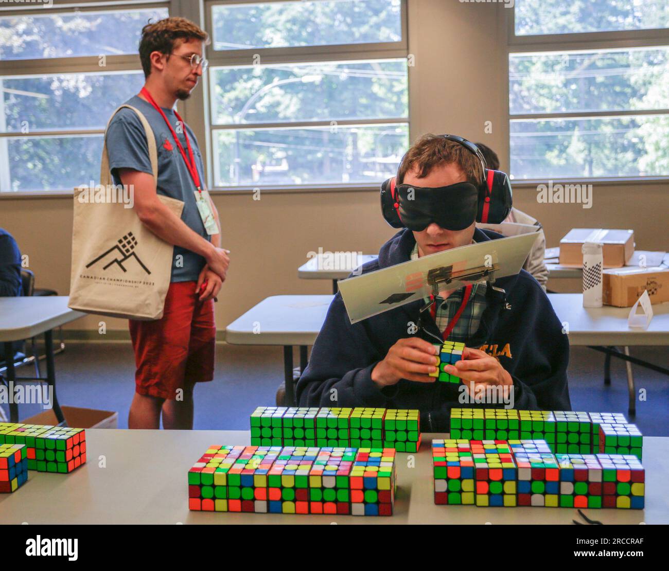 New Westminster, Canada. 13th July, 2023. A contestant solves a Rubik's Cube blindfolded during the Canadian Speedcubing Championship 2023 at the Queen's Park Arena in New Westminster, British Columbia, Canada, on July 13, 2023. A total of 320 contestants from 20 countries and regions took part in the championship from July 13 to 16. Credit: Liang Sen/Xinhua/Alamy Live News Stock Photo