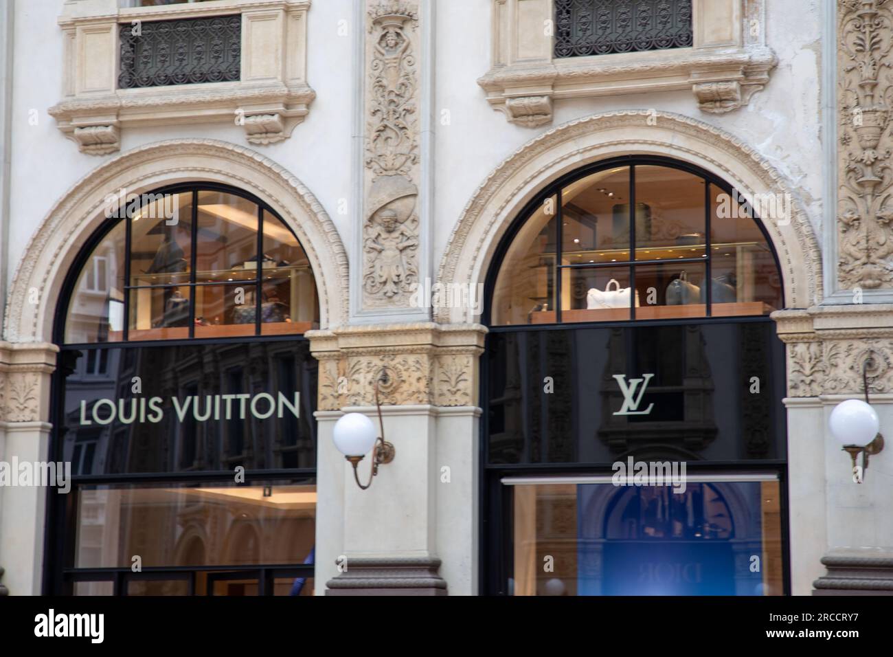 Milan , Italy  - 07 10 2023 : Louis Vuitton logo brand and text sign front entrance facade home shop luxe chain handbag and luggage Stock Photo