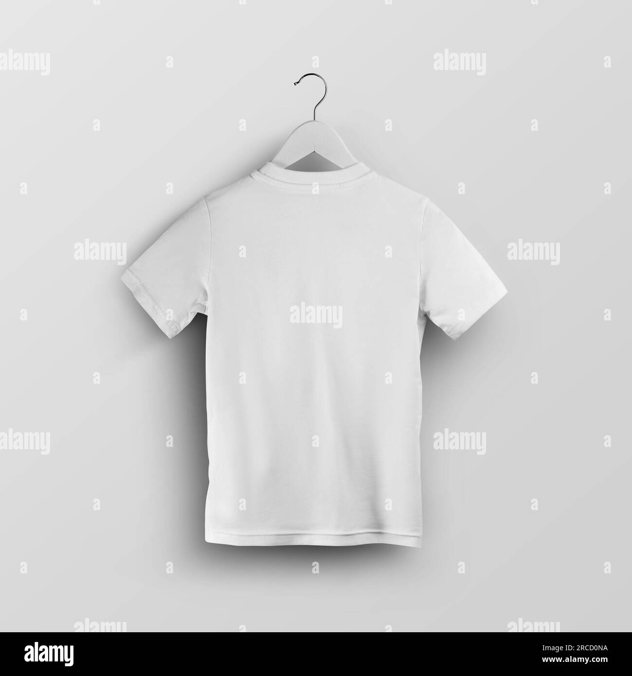 Mockup of a child's white t-shirt on a hanger, fashion clothes, back view, for design, print. Template of stylish kids shirt, isolated on the backgrou Stock Photo