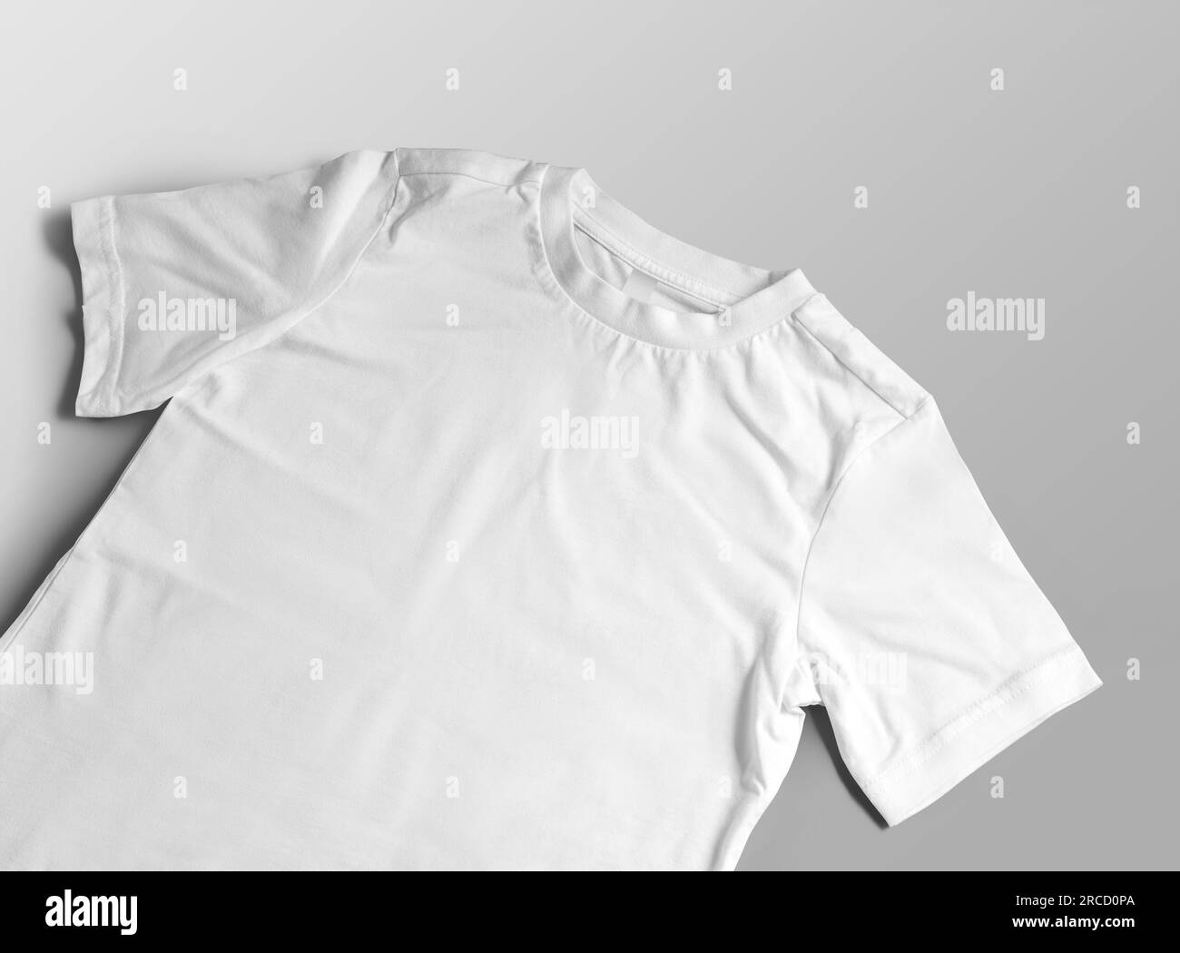 Mockup of white children's t-shirt close-up, wear with a round neck, label, close-up, diagonal presentation, front view. Product photography for desig Stock Photo