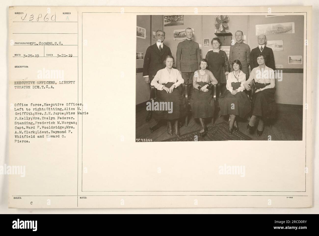 Executive officers of Liberty Theatre Division, T.C.A., pictured in their office on March 21, 1919. From left to right, sitting: Alice M. Griffith, Mrs. J.H. Joyce, Miss Marie F. Kelly, Mrs. Evelyn Federer. Standing: Frederick M. Morgan, Capt. Ward P. Wooldridge, Mrs. A.M. Clark, Lieut. Raymond P. Whitfield, and Howard O. Pierce. Stock Photo
