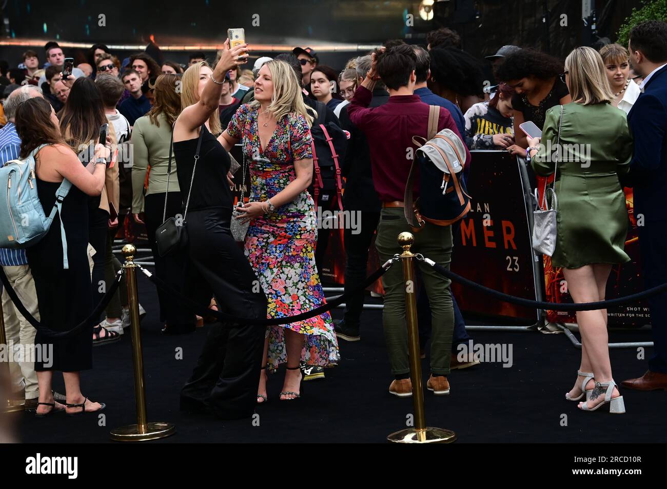 London, UK. 13 July 2023. Attendees taking selfie at Oppenheimer - UK Premiere at ODEON Luxe, Leicester Square, London, UK. Stock Photo