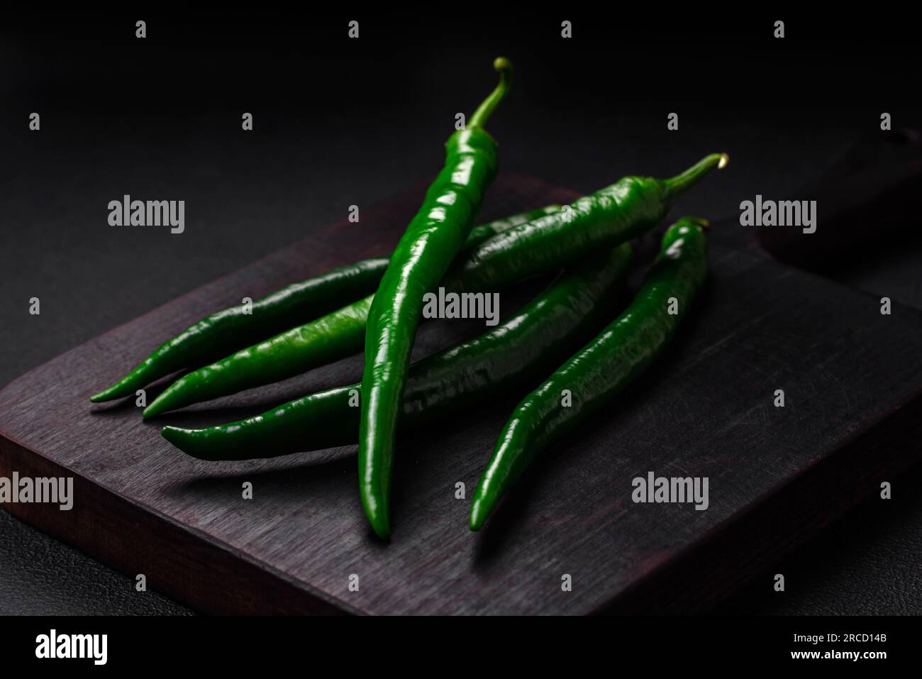 Fresh hot green chili peppers on a dark concrete background. Hot Sauce ...