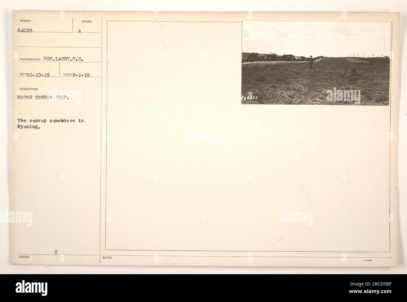 A motor convoy makes its way through the Wyoming landscape during a trip. This photograph was taken on August 1, 1919, and is part of the StillPix Finding Aid collection. The convoy is seen traveling along a road in Wyoming. The notes accompanying the photograph list the symbol issued as well. Stock Photo