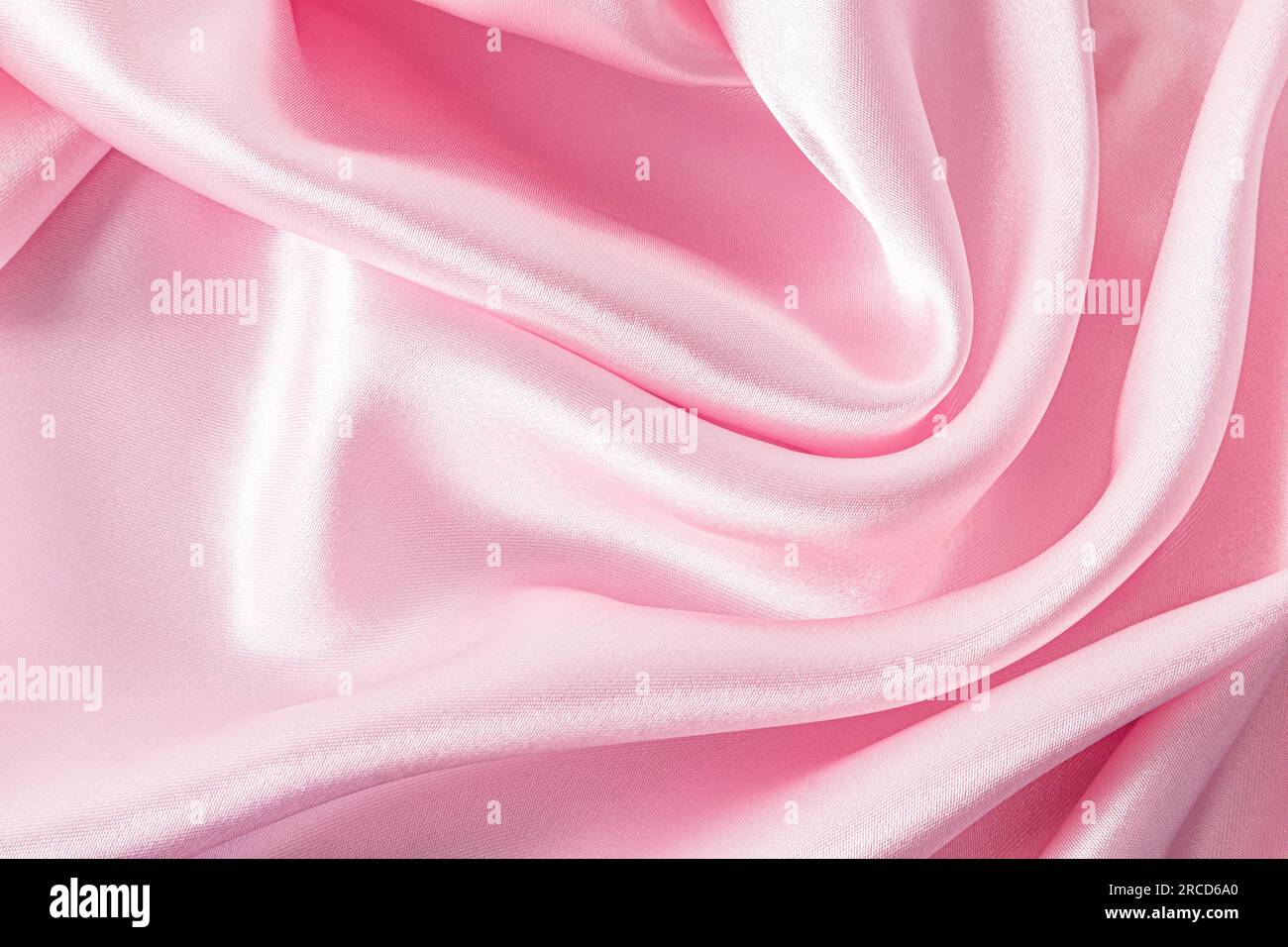 Elegant satin fabric with a pink color. The luxurious texture of the ...