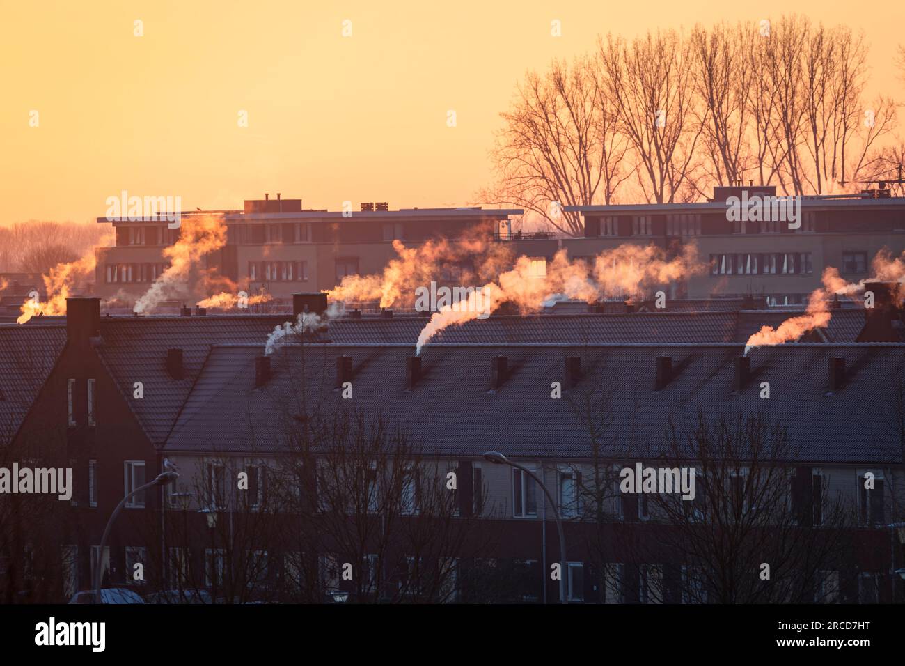 A roofscape in the Netherlands in winter, with homes being heated by